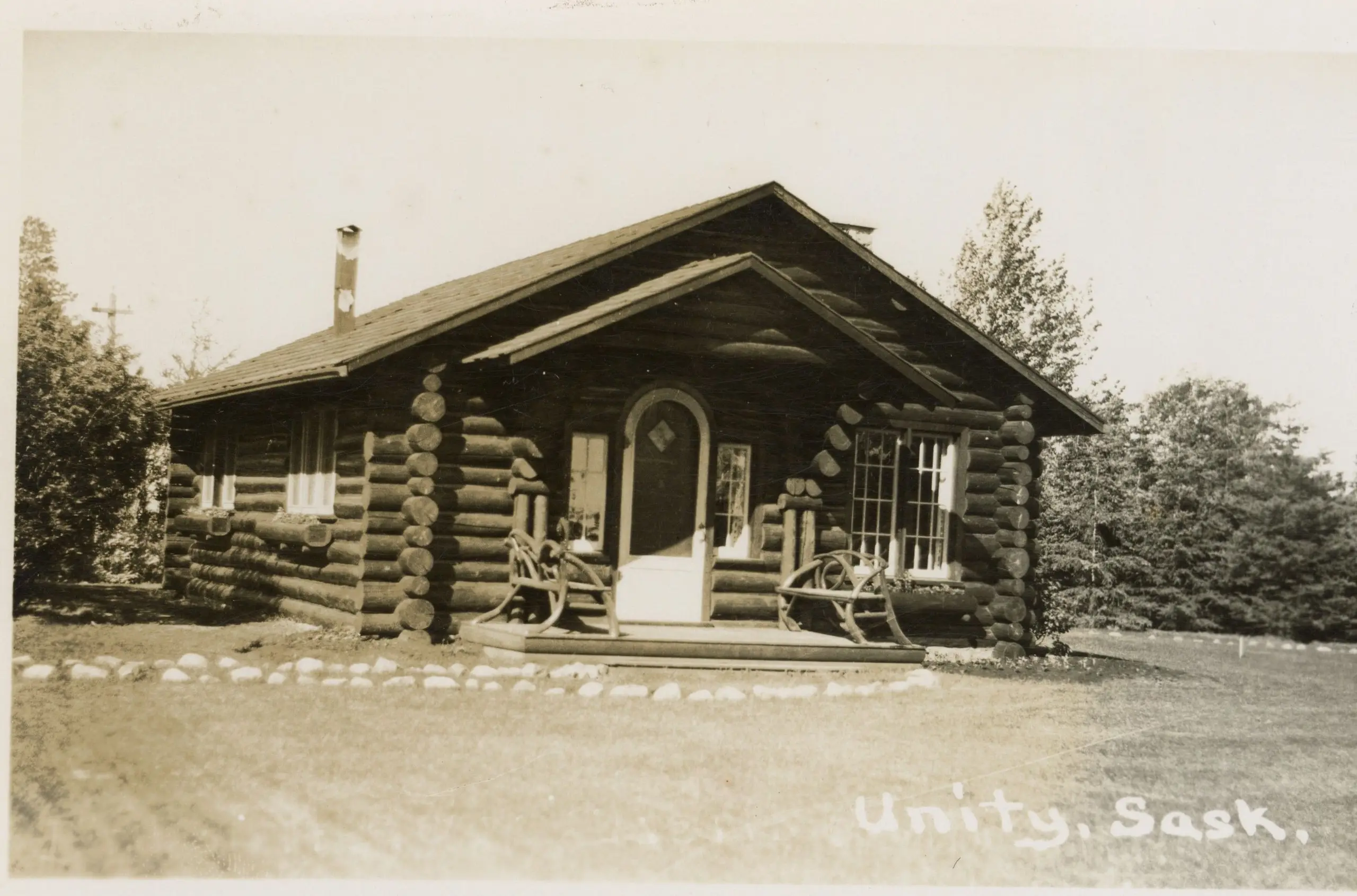 Log cabin with rustic porch chairs